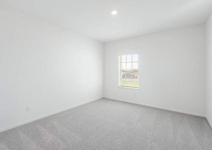 Master bedroom with lush carpet flooring