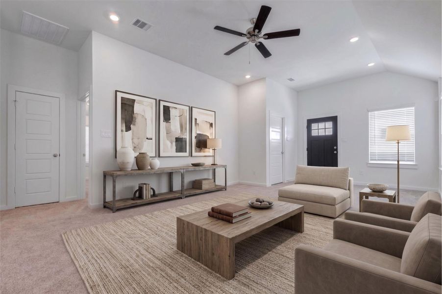 Bright living room with high ceilings, neutral walls, plush carpet, recessed lighting, ceiling fan, and a window near the front entry. This flexible space offers plenty of room for comfortable seating and connects easily to the rest of the home. This photo has been virtually staged for visual reference.