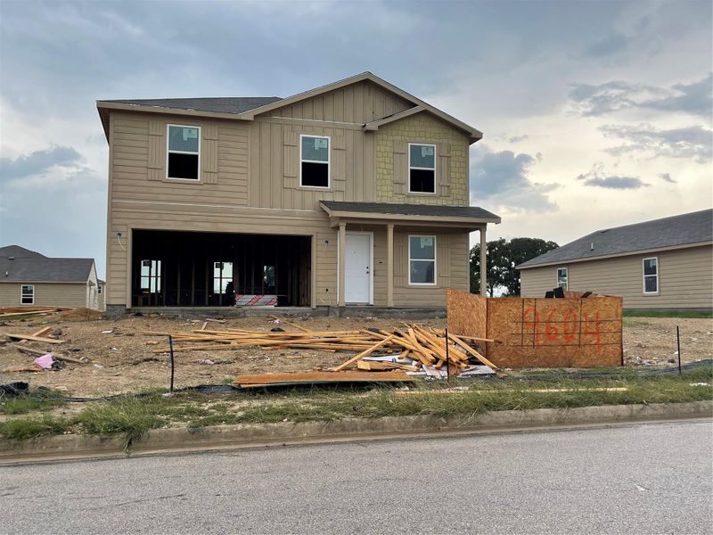 View of front of home with board and batten siding and a garage