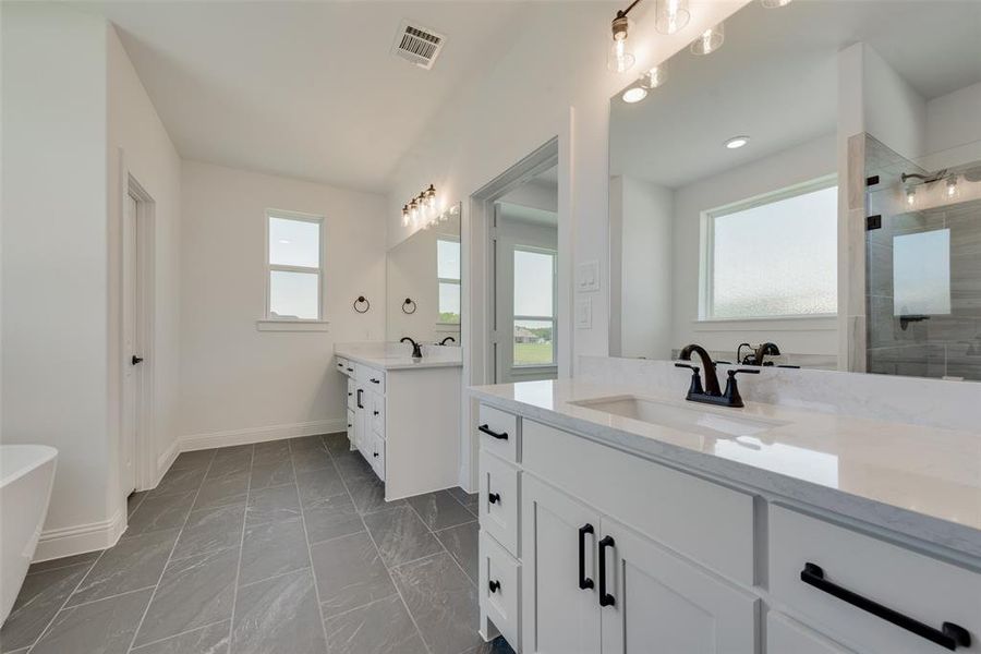 Bathroom featuring independent shower and bath, tile patterned floors, and double sink vanity