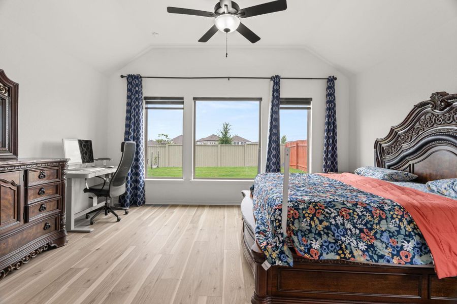 Hardwood floors and vaulted ceilings elevate this sun-drenched bedroom with ample natural illumination. Hardwood floors and vaulted ceilings elevate this sun-drenched bedroom with ample natural illumination.