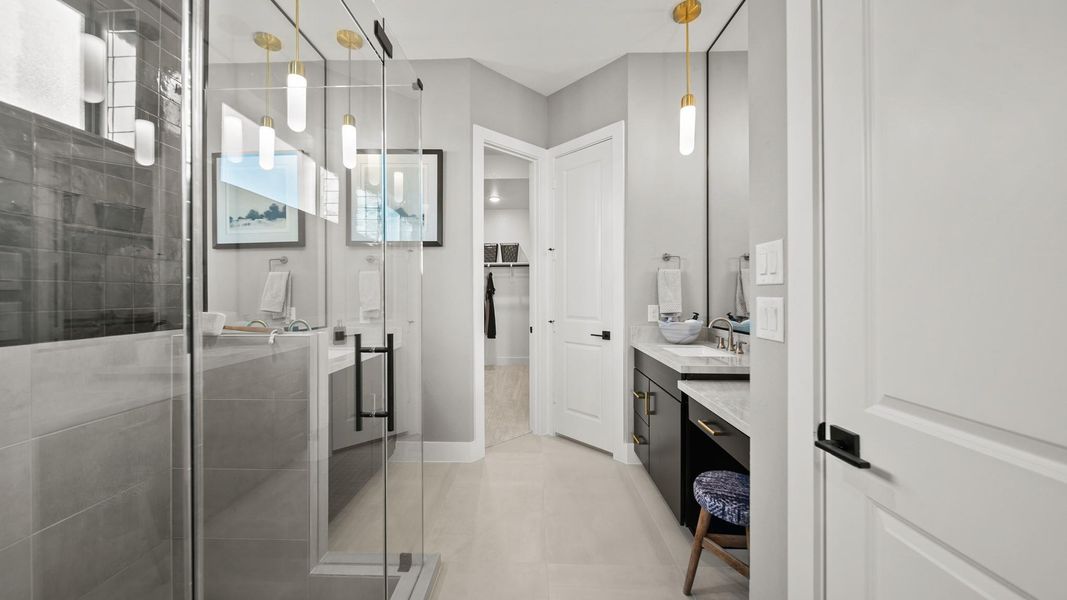 Behind the sliding barn-door, this retreat style main bathroom greets you with a huge full glass-surrounding shower fitted with matte black hardware. Black tile to the ceiling with modern gold pendants over the sinks give this bathroom a vibrant pop of style! Behind the sliding barn-door, this retreat style main bathroom greets you with a huge full glass-surrounding shower fitted with matte black hardware. Black tile to the ceiling with modern gold pendants over the sinks give this bathroom a vibrant pop of style!
