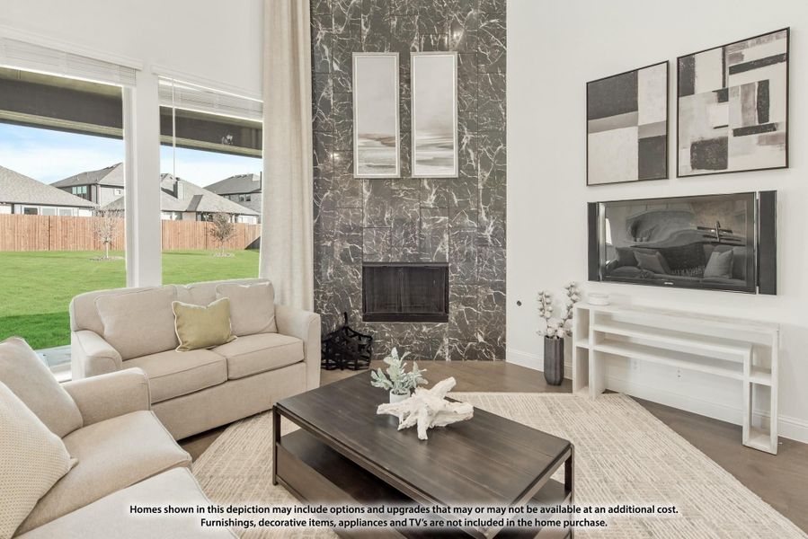 Living room with dark marble fireplace surround, large windows, neutral sofa seating, and hardwood floors Living room with dark marble fireplace surround, large windows, neutral sofa seating, and hardwood floors