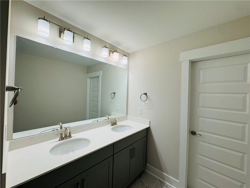 This modern bathroom features a spacious dual vani