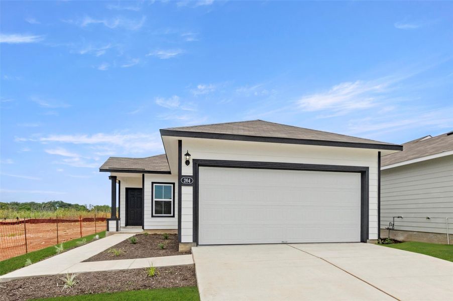 Ranch-style home with a shingled roof, concrete driveway, and an attached garage