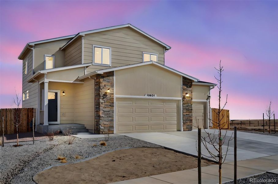Front exterior of a new home in , Peyton, CO, highlighting curb appeal (Image 1). Front exterior of a new home in , Peyton, CO, highlighting curb appeal (Image 1).