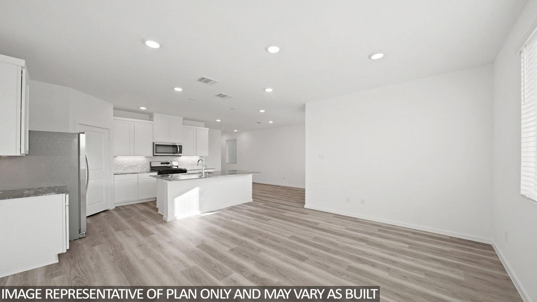 Open-concept living space featuring wood-finish flooring, recessed lighting, and white walls