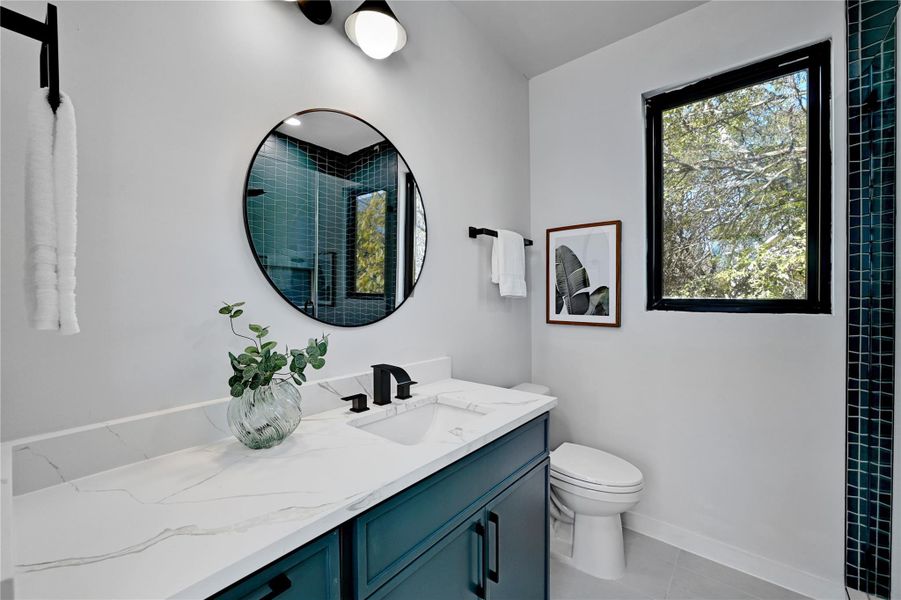 Bathroom with tile patterned floors, an enclosed shower, toilet, baseboards, and vanity