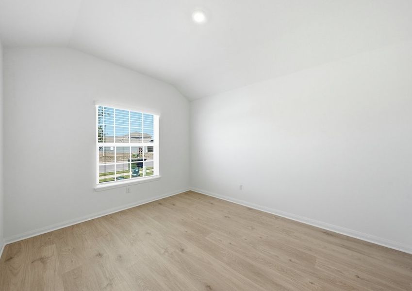 Dining room featuring a window with natural light and wood-look vinyl flooring. Dining room featuring a window with natural light and wood-look vinyl flooring.