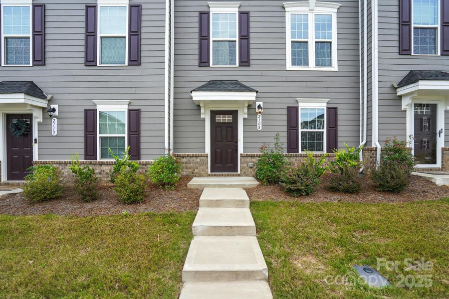 Front exterior of a new home in , Matthews, NC, highlighting curb appeal (Image 24).