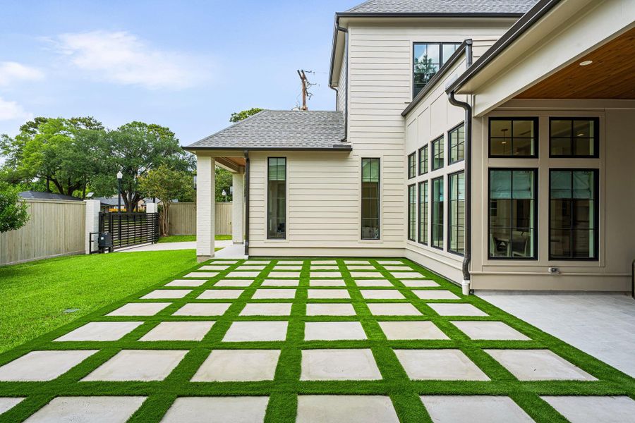 Thoughtfully designed outdoor space featuring concrete pavers set in a grid pattern w/ turfed joints, creating a clean, modern look. Tons of room for outdoor furnishings. Additional greenspace offers flexibility for pets, play or future enhancements, all within a well-balanced and usable backyard setting. Thoughtfully designed outdoor space featuring concrete pavers set in a grid pattern w/ turfed joints, creating a clean, modern look. Tons of room for outdoor furnishings. Additional greenspace offers flexibility for pets, play or future enhancements, all within a well-balanced and usable backyard setting.