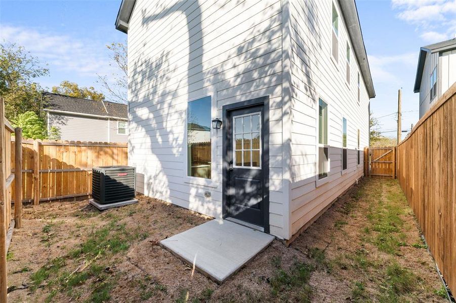 Back of house featuring a fenced backyard and a gate Back of house featuring a fenced backyard and a gate