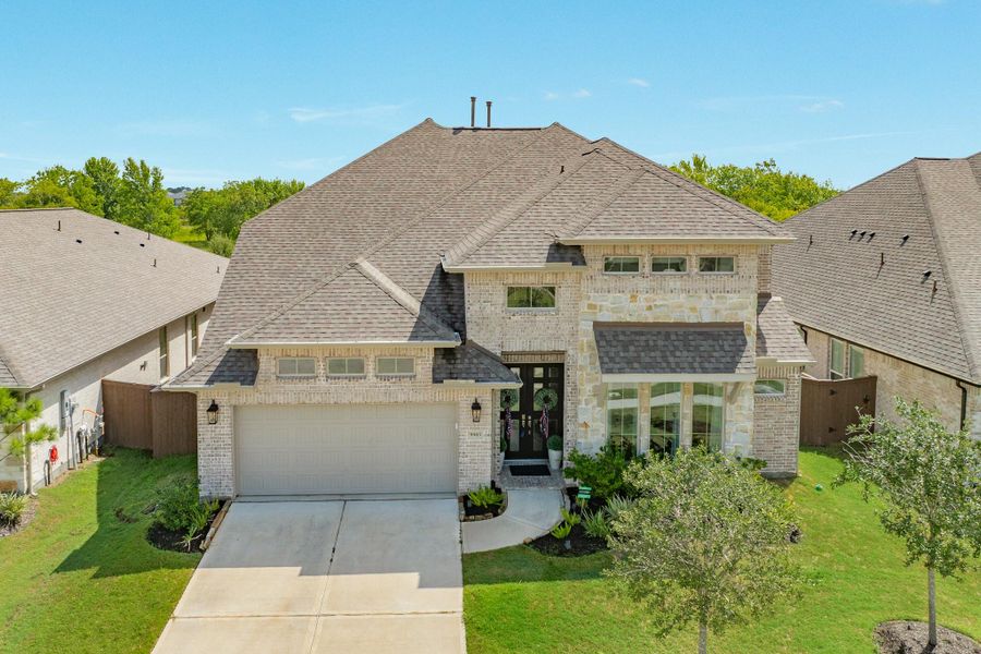 Aerial view of your new home featuring a 2-year-old 30-year roof. The property boasts stunning landscaping leading to a 3-car tandem garage and a spacious double-wide driveway. Aerial view of your new home featuring a 2-year-old 30-year roof. The property boasts stunning landscaping leading to a 3-car tandem garage and a spacious double-wide driveway.