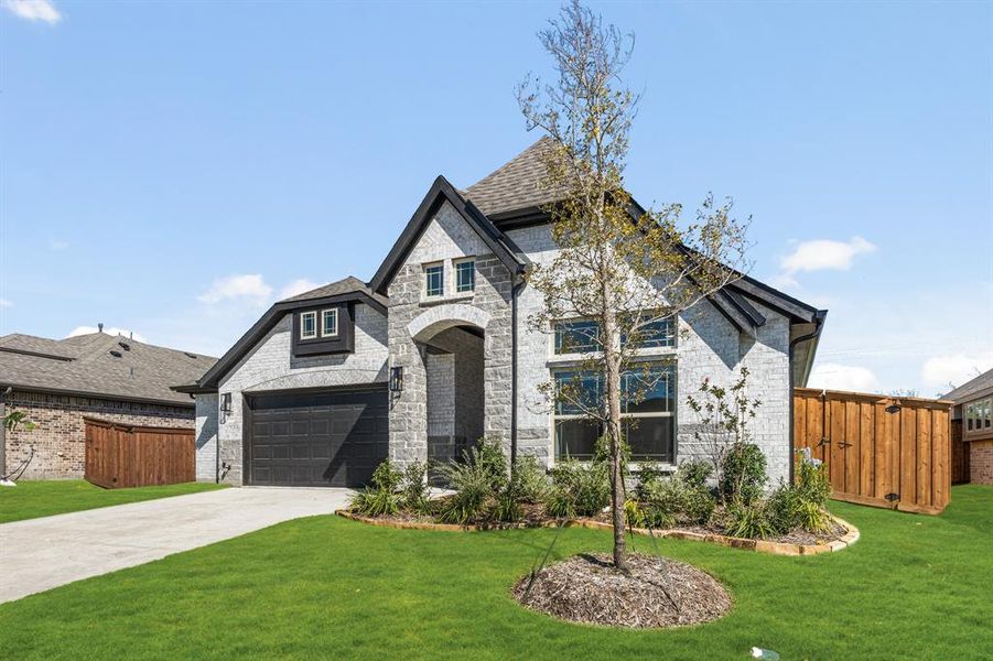 Front exterior of a new home in Waterscape Classic 60s, Royse City, TX, highlighting curb appeal (Image 2).