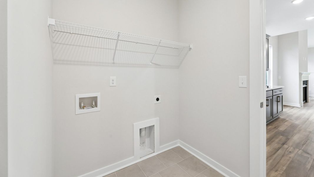 Dedicated laundry room with ventilated shelf Dedicated laundry room with ventilated shelf