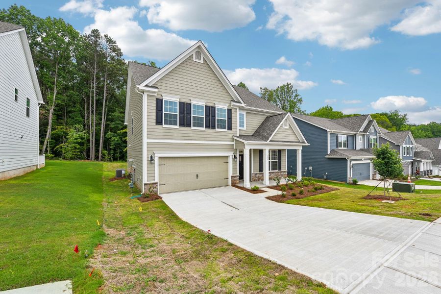 Front exterior of a new home in Falls Cove, Troutman, NC, highlighting curb appeal (Image 21). Front exterior of a new home in Falls Cove, Troutman, NC, highlighting curb appeal (Image 21).