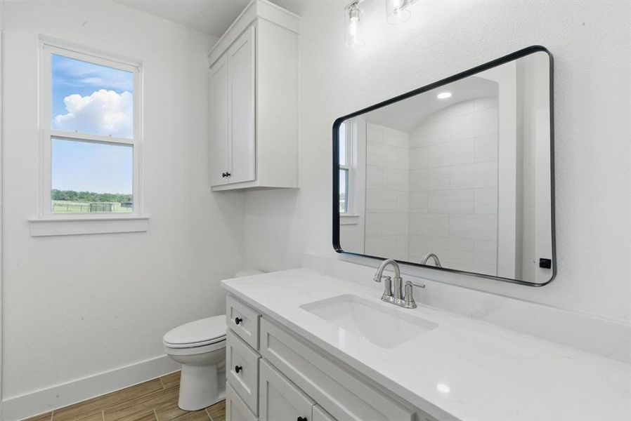 Bathroom featuring vanity and wood finish floors Bathroom featuring vanity and wood finish floors
