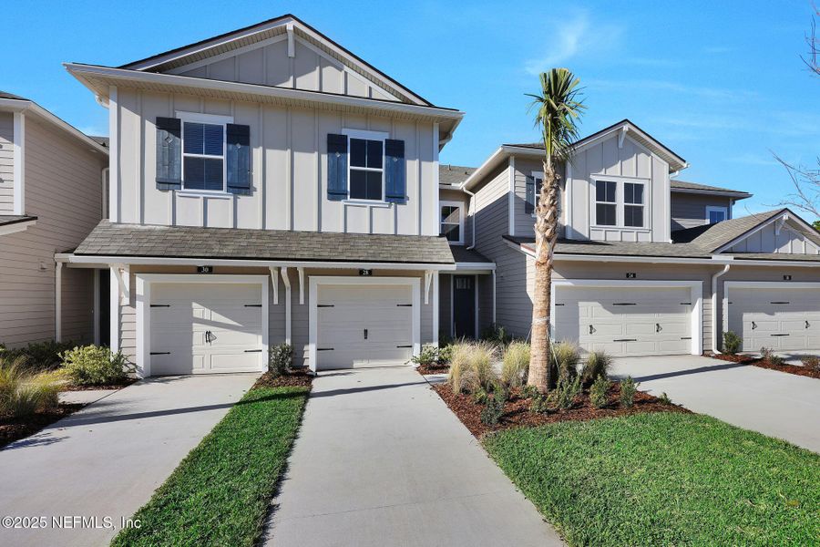 Front exterior of a new home in Woodland Park, Nocatee, FL, highlighting curb appeal (Image 1).