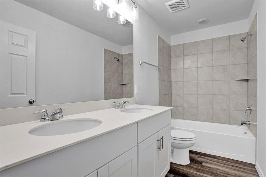 Dual vanity with white cabinetry, integrated sinks, chrome fixtures, and a white countertop