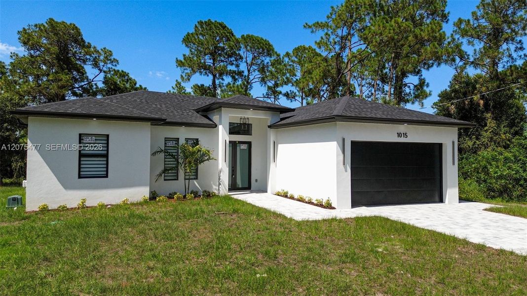 Front exterior of a new home in , Lehigh Acres, FL, highlighting curb appeal (Image 40). Front exterior of a new home in , Lehigh Acres, FL, highlighting curb appeal (Image 40).