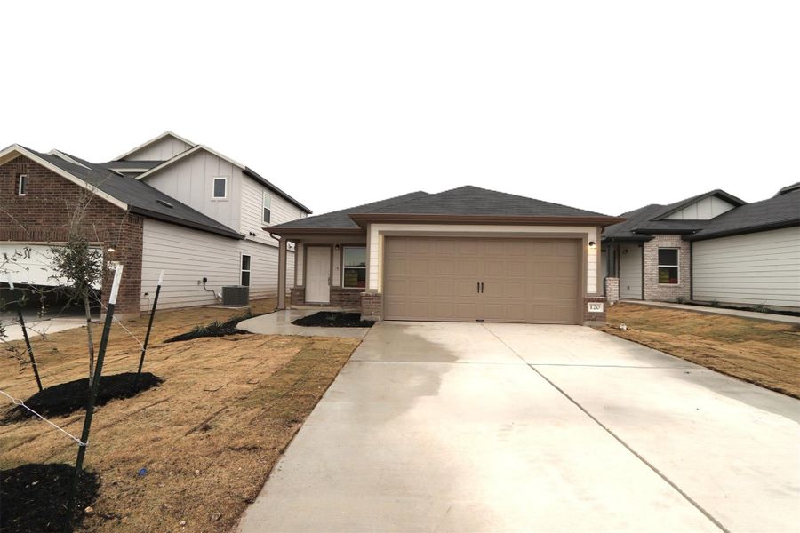 View of front of property featuring a garage, a front yard, and cooling unit