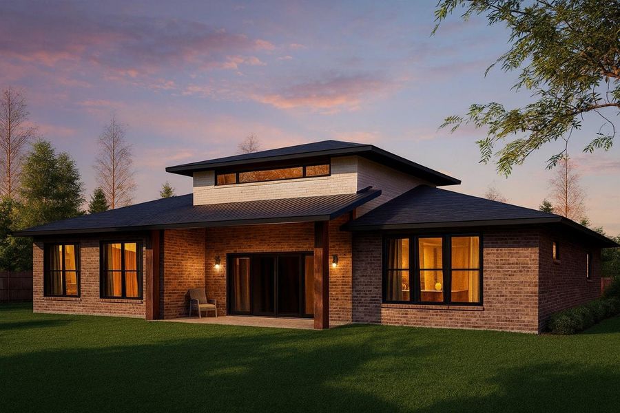 Back of house at dusk featuring brick siding, a patio, and a yard Back of house at dusk featuring brick siding, a patio, and a yard