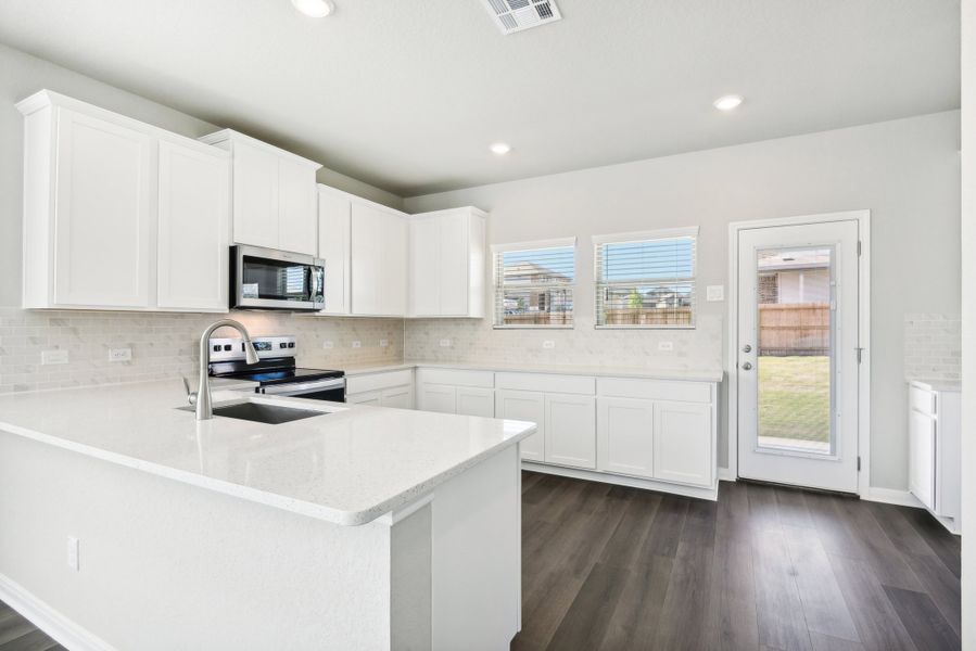 Kitchen in the Medina floorplan at a Meritage Homes community.