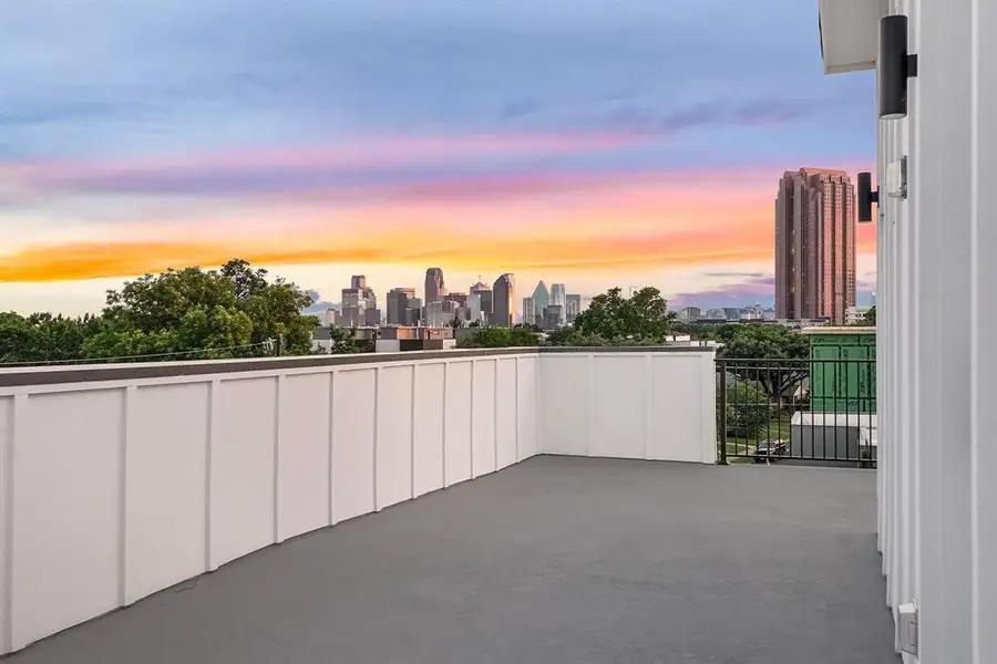 Rooftop deck featuring a cityscape backdrop, low-profile perimeter walls, and contemporary exterior lighting fixtures Rooftop deck featuring a cityscape backdrop, low-profile perimeter walls, and contemporary exterior lighting fixtures