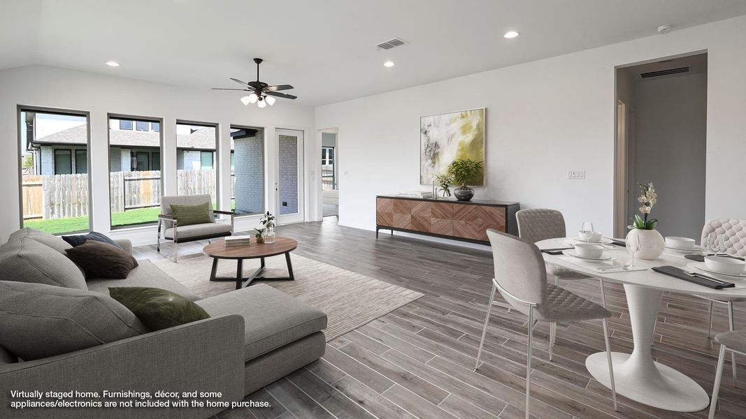 Living area with recessed lighting, wood finished floors, and ceiling fan Living area with recessed lighting, wood finished floors, and ceiling fan