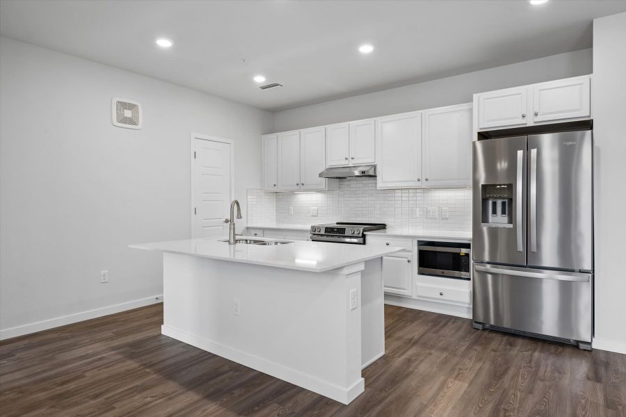 A kitchen with white cabinets. A kitchen with white cabinets.