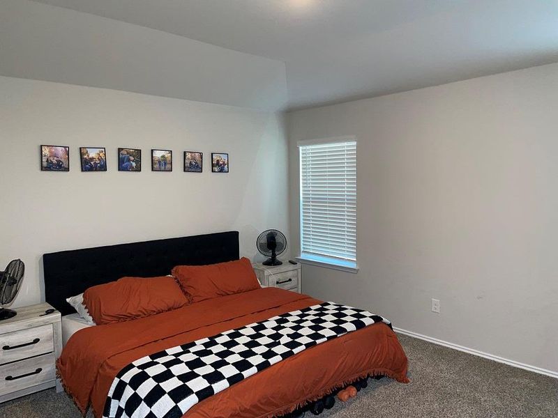 Carpeted bedroom featuring baseboards