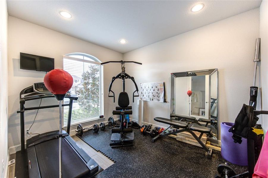 Multi-purpose room serves as a home office or gym.