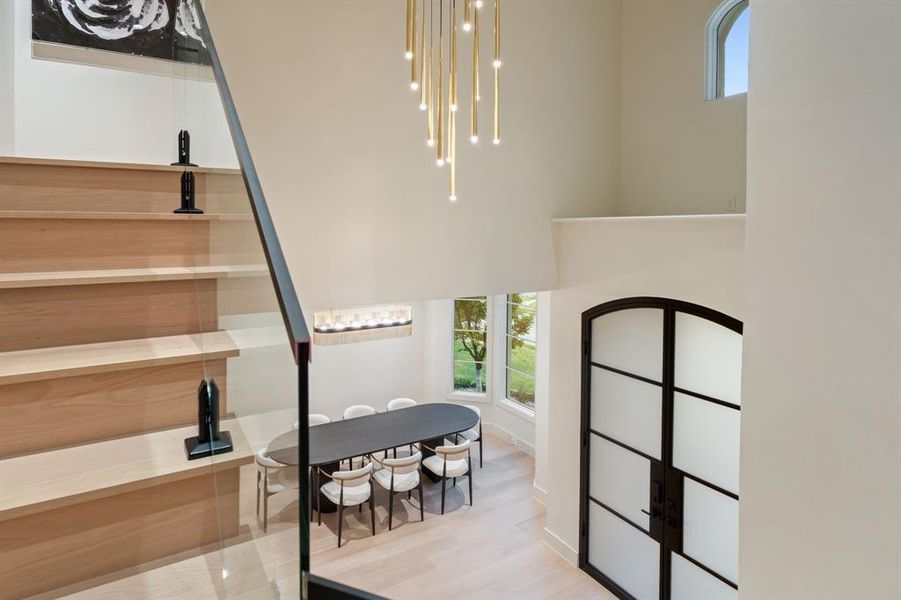 This custom stairway deserves a second look with the glass railing that opens the views to the foyer.