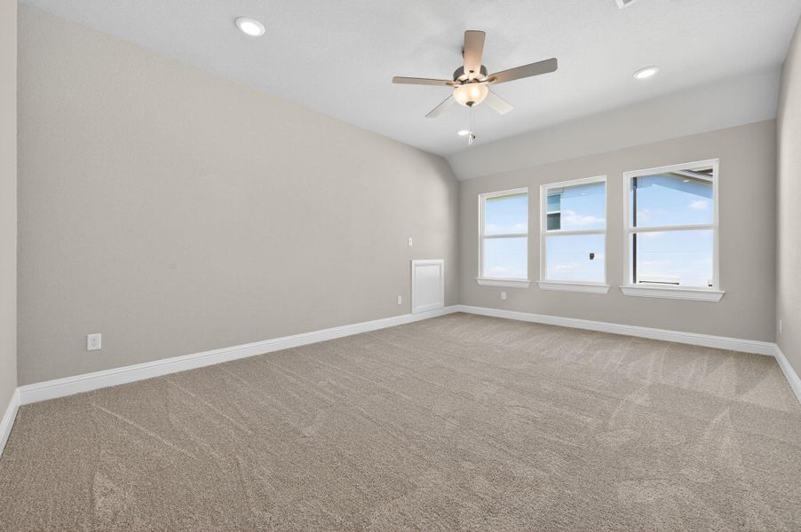Empty room featuring light carpet, a ceiling fan, recessed lighting, and lofted ceiling