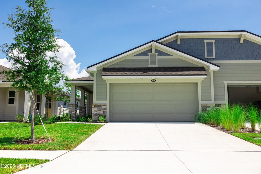 Front exterior of a new home in RiverTown - WaterSong, St. Johns, FL, highlighting curb appeal (Image 2). Front exterior of a new home in RiverTown - WaterSong, St. Johns, FL, highlighting curb appeal (Image 2).