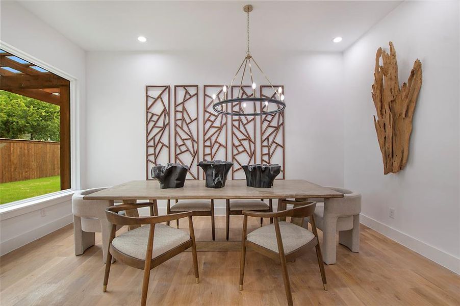 Dining room featuring an inviting chandelier and light hardwood / wood-style floors