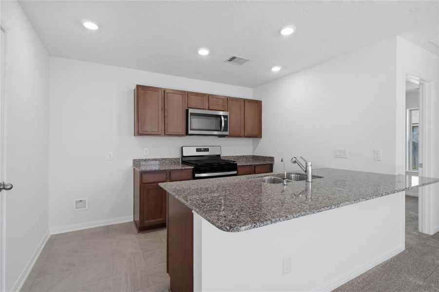 Enjoy a commanding view from the kitchen, showcasing the open-concept living space where you can seamlessly transition from the kitchen to the open-space living area, keeping you connected to the conversation and the view while hosting or relaxing.