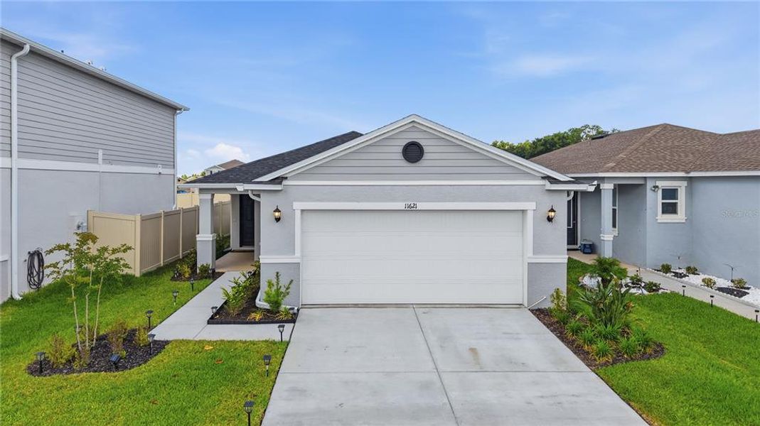 Front exterior of a new home in Magnolia Creek, Riverview, FL, highlighting curb appeal (Image 26). Front exterior of a new home in Magnolia Creek, Riverview, FL, highlighting curb appeal (Image 26).