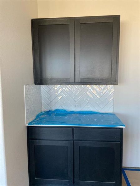Contemporary dark cabinetry featuring shaker-style doors