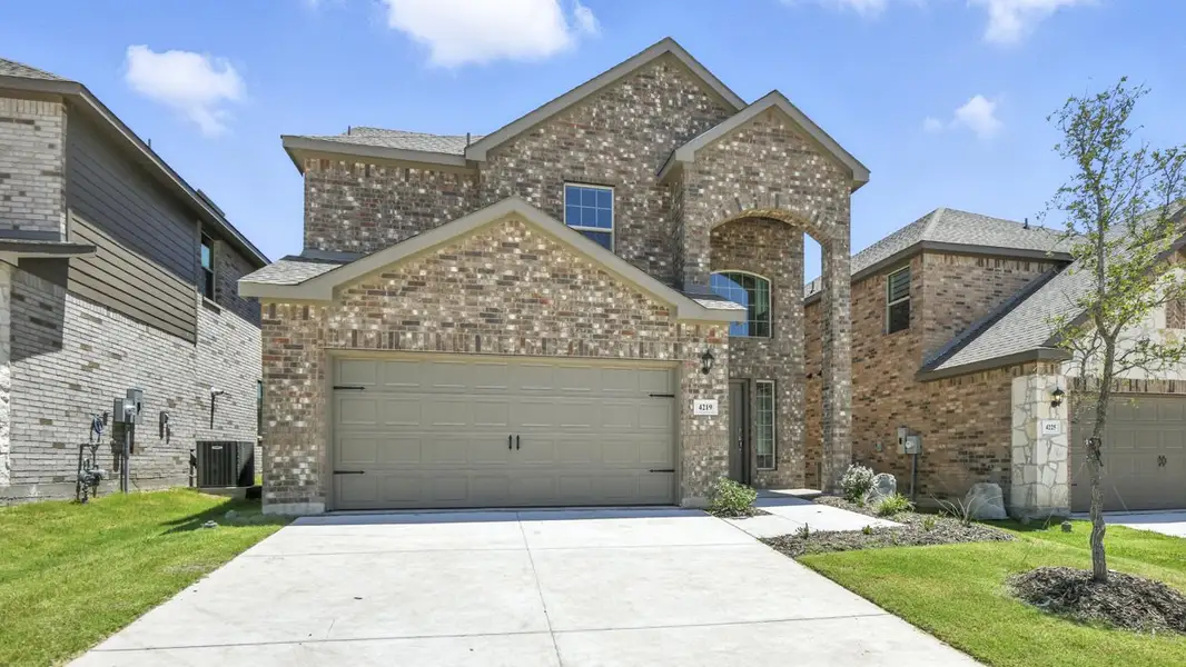 Front exterior of a new home in The Woods at Lindsey Place, Anna, TX, highlighting curb appeal (Image 1). Front exterior of a new home in The Woods at Lindsey Place, Anna, TX, highlighting curb appeal (Image 1).