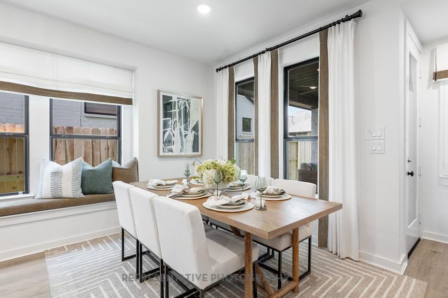 Dining area with light wood-style flooring and baseboards Dining area with light wood-style flooring and baseboards