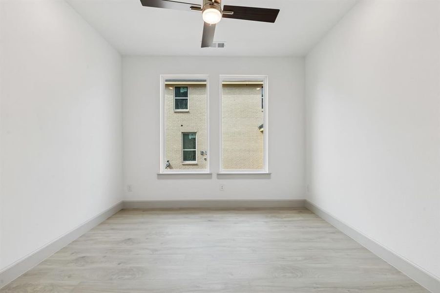 The professional working from home will appreciate this lovely home office filled with natural light.