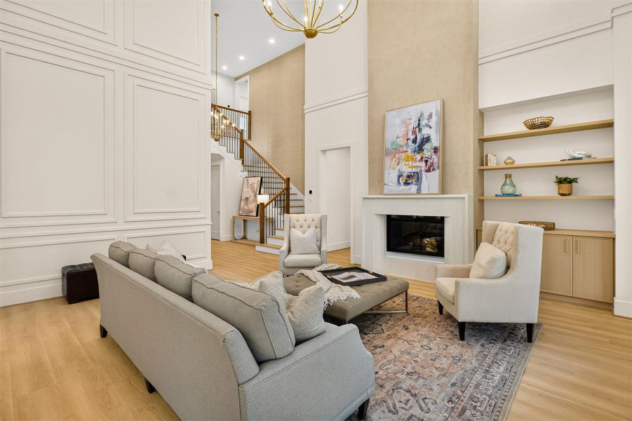 A stunning fireplace with textured surround serves as the focal point of the living area, complemented by custom shelving and cabinetry designed for both style and functionality. A stunning fireplace with textured surround serves as the focal point of the living area, complemented by custom shelving and cabinetry designed for both style and functionality.