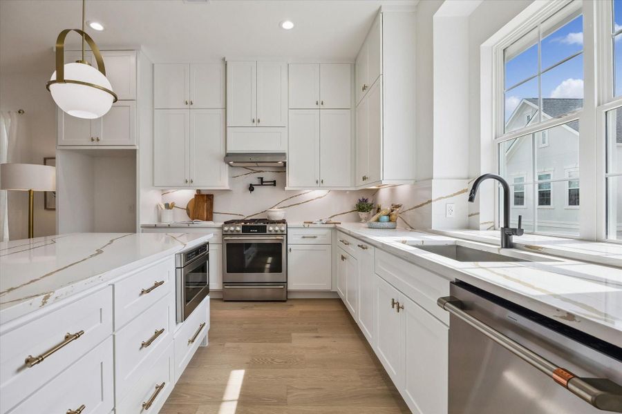 Quartz countertops, designer tile, and soft-close shaker-style cabinets are hallmark features of Riverway Homes in Somerset Green.