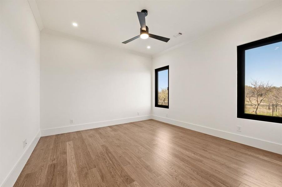 Spare room with light wood-style flooring, crown molding, ceiling fan, and recessed lighting