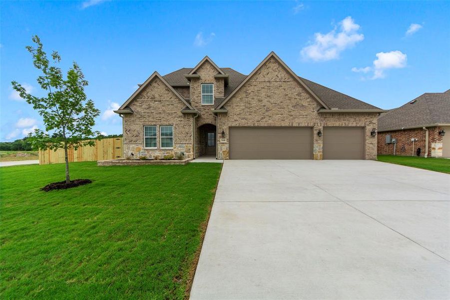 Front exterior of a new home in , Greenville, TX, highlighting curb appeal (Image 2). Front exterior of a new home in , Greenville, TX, highlighting curb appeal (Image 2).