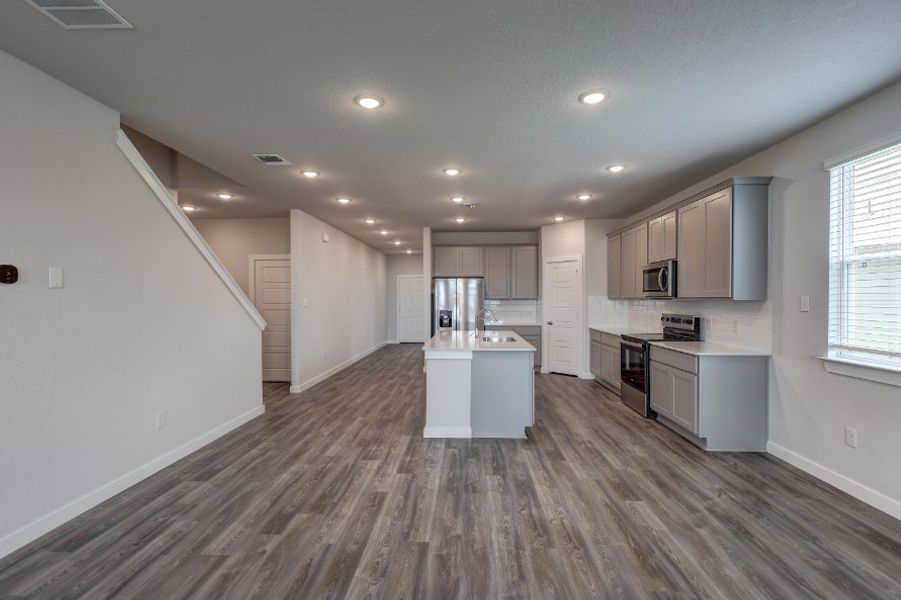A kitchen with white cabinets.