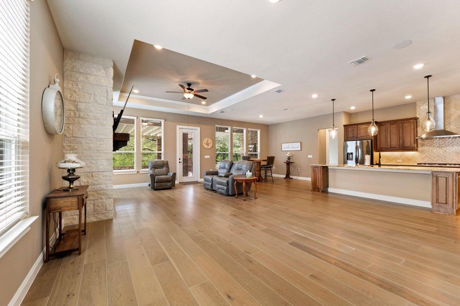 An open concept design seamlessly merges living and culinary spaces, grounded by robust hardwood flooring. An open concept design seamlessly merges living and culinary spaces, grounded by robust hardwood flooring.