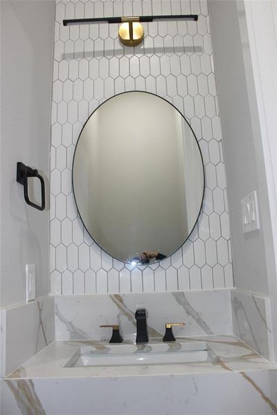 Bathroom with vanity and decorative backsplash