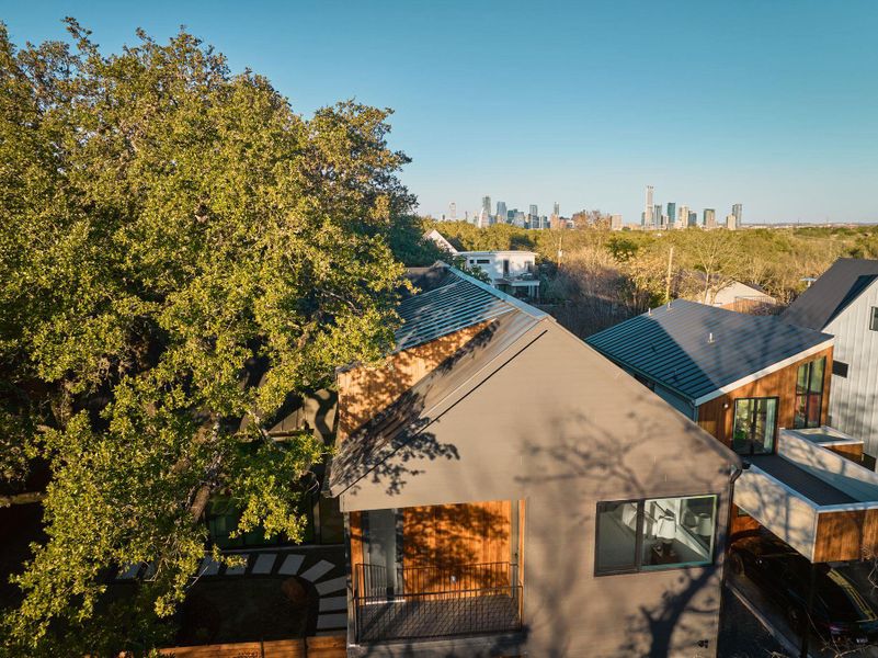 Aerial view of property and surrounding area with city skyline